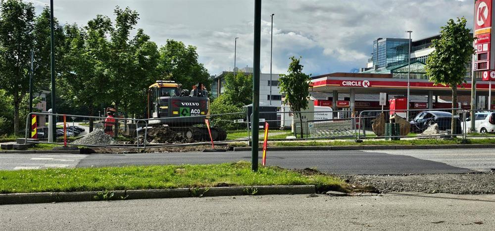 asfaltert veg med gravemaskin bak - Klikk for stort bilete